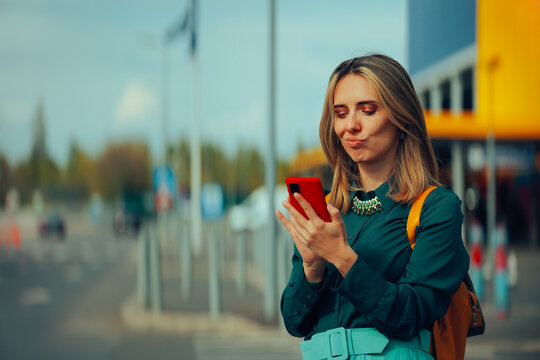 Funny Woman Checking her Mobile Phone. Happy girl looking for car renting app in a big city
