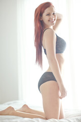 Girl, lingerie and bed with portrait with smile for healthy body, confidence and relax in home. Woman, person and wake up in underwear, holiday and happy on sheets in bedroom at apartment in Dublin