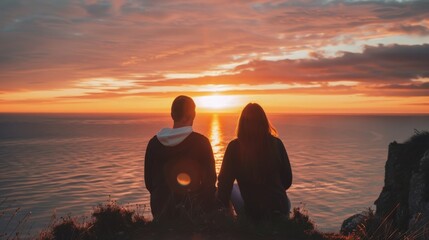 A couple enjoying a quiet moment watching the sunset from a cliff
