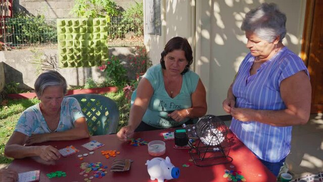elderly neighbours playing bingo outside