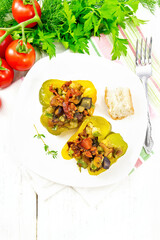 Pepper stuffed with vegetables in plate on board top