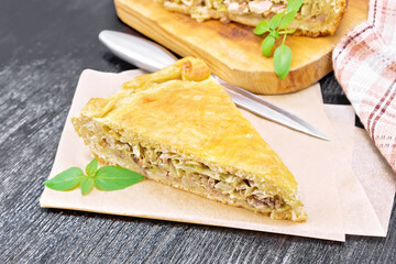Pie with meat and cabbage on board