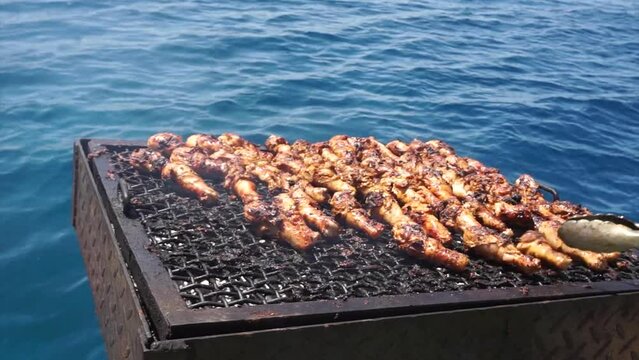 Grilling chicken with the backdrop of the Red Sea in Jordan.