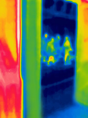 People on the surveillance camera screen.Image from thermal imager device.