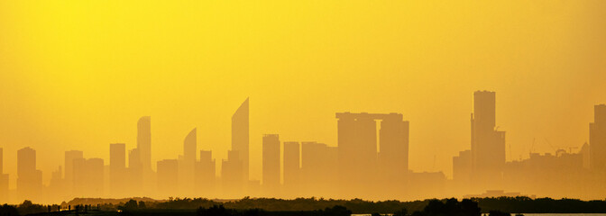 Sandstorm, samum, haboob over the southern megalopolis, the outline of skyscrapers are drowning in yellow haze. Abu Dhabi