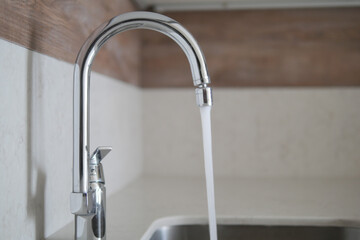 water pouring from a faucet tap slow motion 