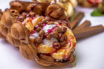 Hong Kong waffle with ice cream, topping, berries and sweets