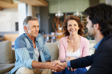 Mature couple, broker and handshake in house for mortgage for retirement in planning, finances and...