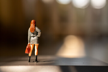 Miniature people ,  A businesswoman standing alone with a suitcase