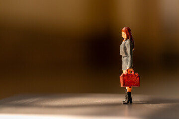 Miniature people ,  A businesswoman standing alone with a suitcase