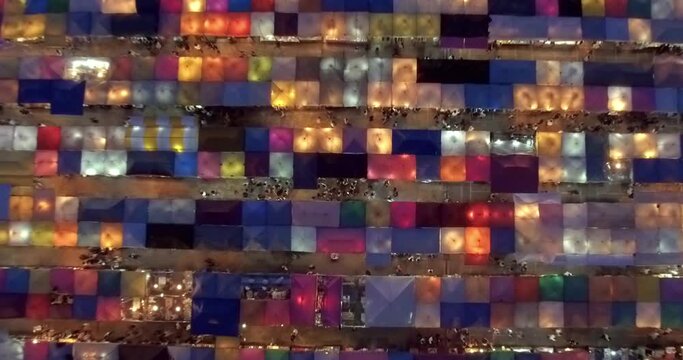Time-lapse view of the colorful market, traditional Train Night Market Ratchada and the Neon Train Market in Bangkok, Thailand, captured by drone footage.