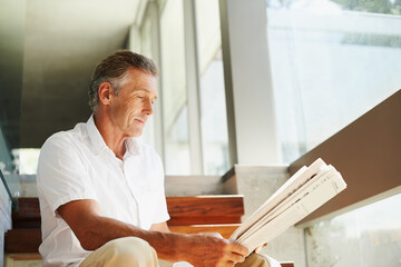 Old man, reading and newspaper in home or article for global current events, stock market or...
