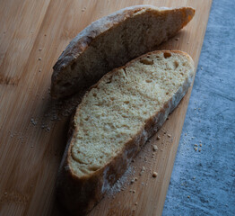 Slices of domestic bread on a cutting wooden board