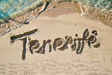 Tenerife, Spain written in the sand on a beach. Spanish tourism and vacation background