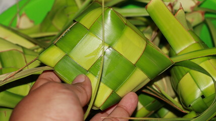 Ketupat is a food made from rice which is wrapped in woven young coconut leaves