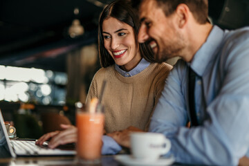 Shot of a young man and woman having a meeting in a cafe