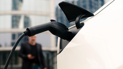 Close-up of a modern electric car charging. The concept of modern technologies, advertising of...