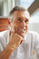 Senior man, smile and thinking at home for decision, choice or idea on retirement and pension....