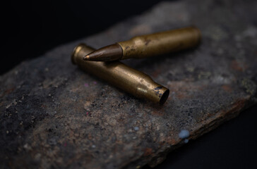 Two empty 7.62mm rounds laying on each other