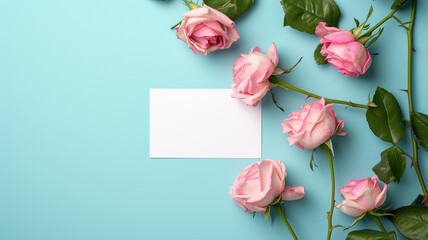A photograph of a blank white card mockup adorned with delicate pink roses
