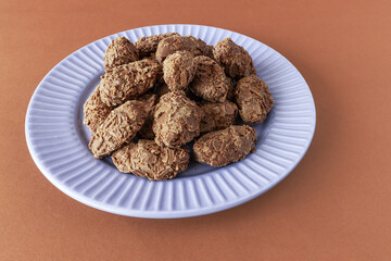 Belgian milk chocolate flakes truffles on brown background