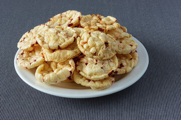 Potato chips with red beets on a dark cloth tablecloth