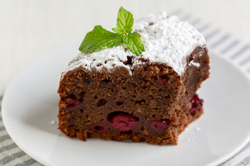 Piece of chocolate pie with cherries.