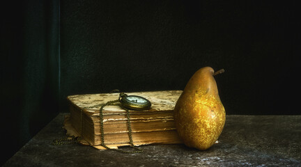 Still life with a pocket watch, a ripe pear and old books.