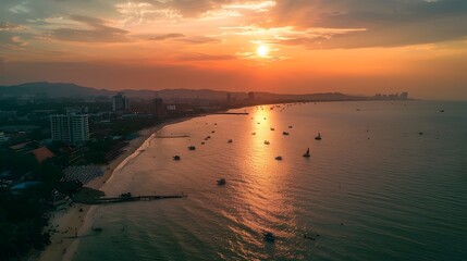 Scenic Aerial View of Pattaya Beach at Sunset with Glowing Horizon - obrazy, fototapety, plakaty