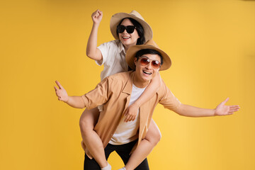 Portrait image of couple posing on yellow background, summer, travel