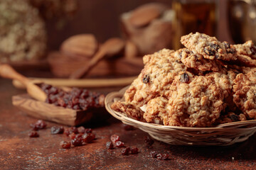 Oatmeal raisin cookies on a brown table.