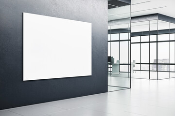 A blank white poster on a dark wall inside a modern office corridor with glass partitions and an outdoor view, concept of advertising space. 3D Rendering