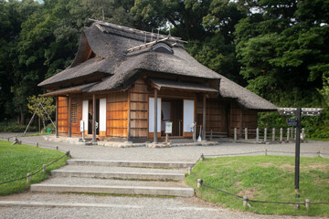 Fototapeta na wymiar Traditional Japanese chashitsu tea room called Tsubame-no-ochaya or Swallow teahouse along the Shiori-no-ike pond of the Hama-rikyū Gardens