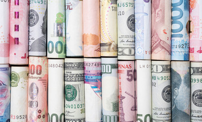 Various international banknotes roll in the world for currency exchange and transfer of forex...