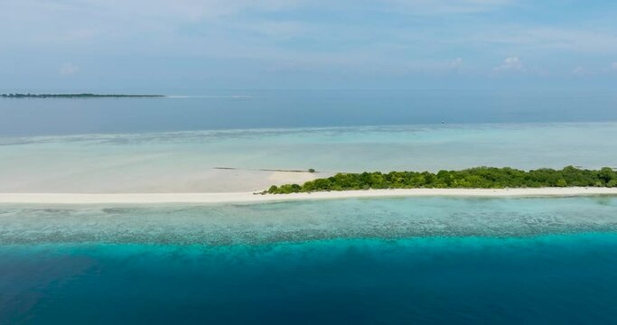 Aerial drone of sandy tropical island with a beautiful beach surrounded by a coral reef. Timba Timba islet. Tun Sakaran Marine Park. Borneo, Sabah, Malaysia.