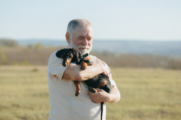 Fields of Happiness Senior Man and Dachshund Create Memories in Sunset's Embrace