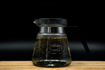 green tea brewing on black background