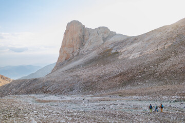 climbers with backpacks in the mountains. Tourists travel to the mountains. Active recreation in nature. Adventure in the mountains.