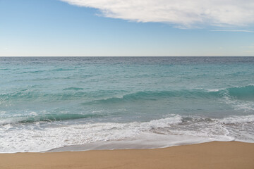Fototapeta na wymiar Empty sand beach on Mediterranean sea with horizon line vacation background