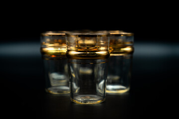 glasses with gold rings on black 