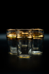 glasses with gold rings on black background 