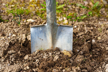 High angle view of spade gardening tool at vegetable bed of home garden at Swiss City of Z&uuml;rich on a cloudy spring morning. Photo taken April 28th, 2024, Zurich, Switzerland.