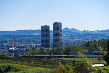 Scenic landscape with skyline of Stettbach and mountain panorama in the background at Swiss City of Zürich on a sunny spring day. Photo taken April 27th, 2024, Zurich, Switzerland.