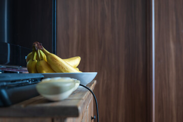 Fresh ripe banana fruit on table next to tv