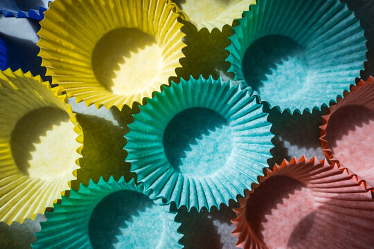 A variety of colorful cupcake liners arranged on a table for baking