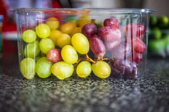 Fresh mixed color grapes inside plastic packaging