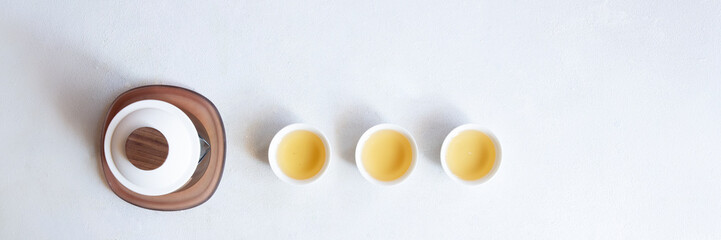 Asian tea concept banner with with white cups of tea and teapot
