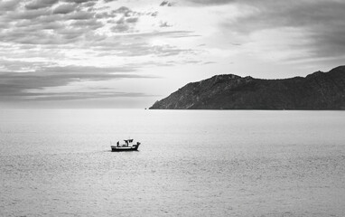 Solitary Fishing Boat at Dusk Near Coastal Mountain, Catalonia