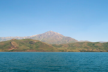 Mount Artos seen from Lake Van, Van Gölü, the intense blue color of the water in the foreground and the dormant volcano in the background, Van, Turkey