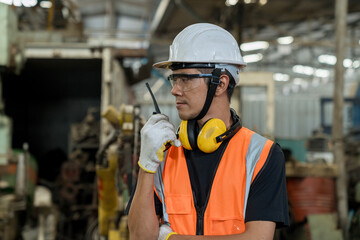 Engineer are working with walkie talkie transmitter. Worker in factory with walkie talkie...